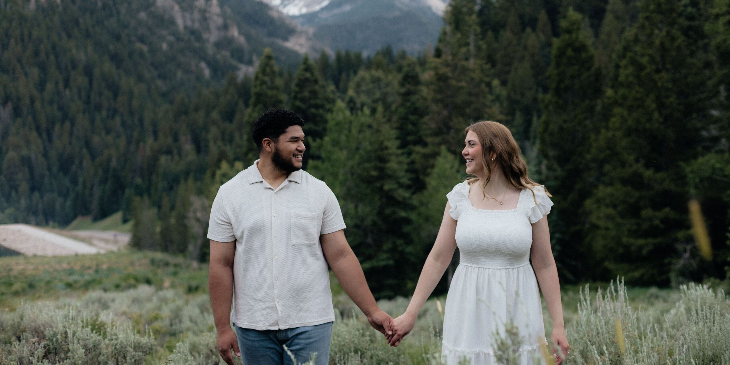 Ashley and Ilan holding hands in nature